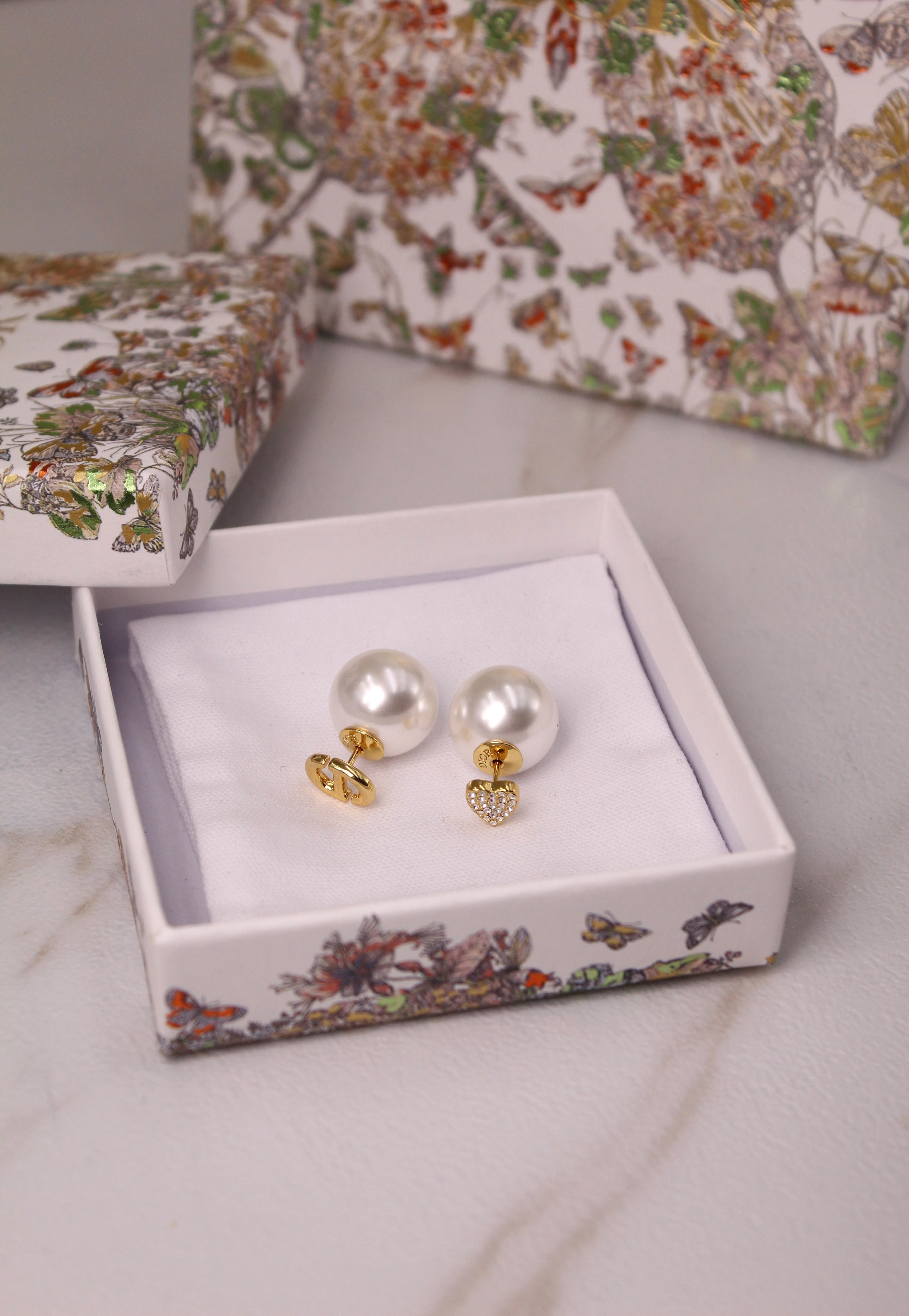 Dior Tribales pearl earrings in butterfly gift box – front view